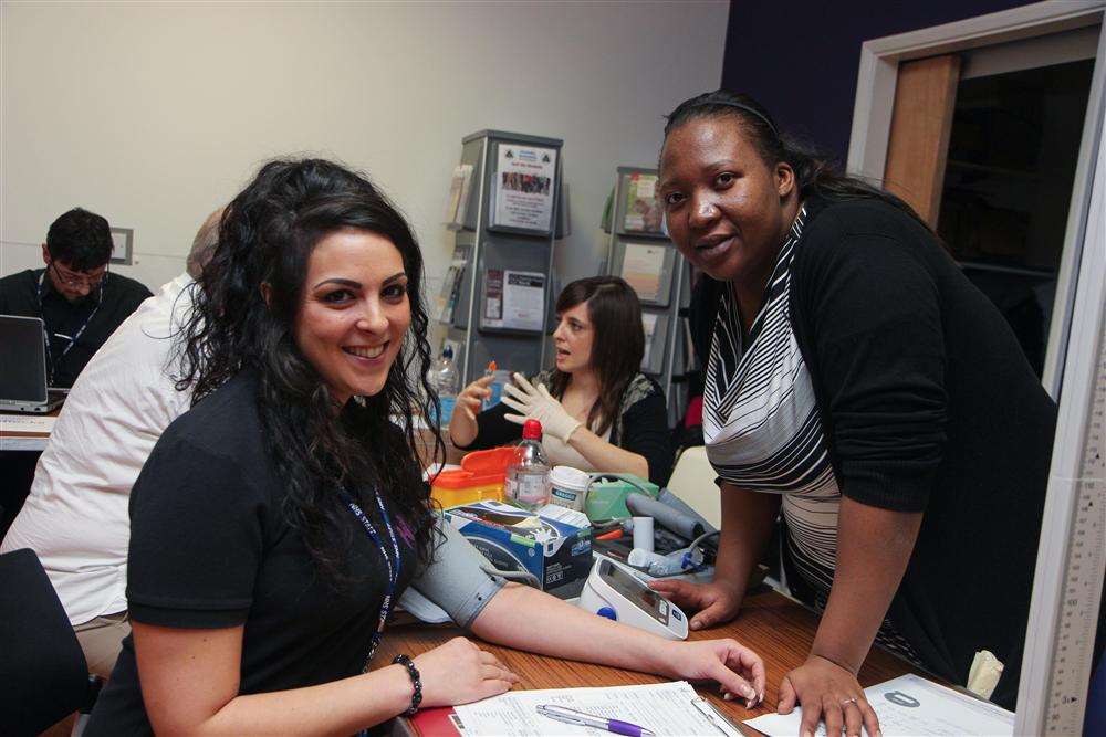 Natasha Baines has her blood pressure checked by Maria Chikura Koht at Sheppey Gateway's New Year, New You event