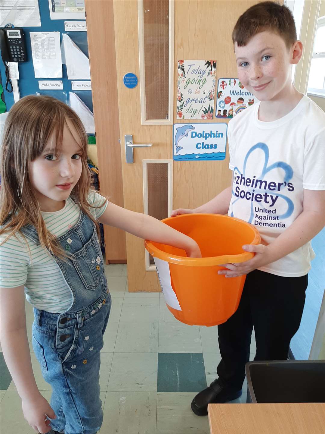 Young Emily Yarrow gives money to Charlie's collection. Picture: St Mary’s C of E Primary School, Dover