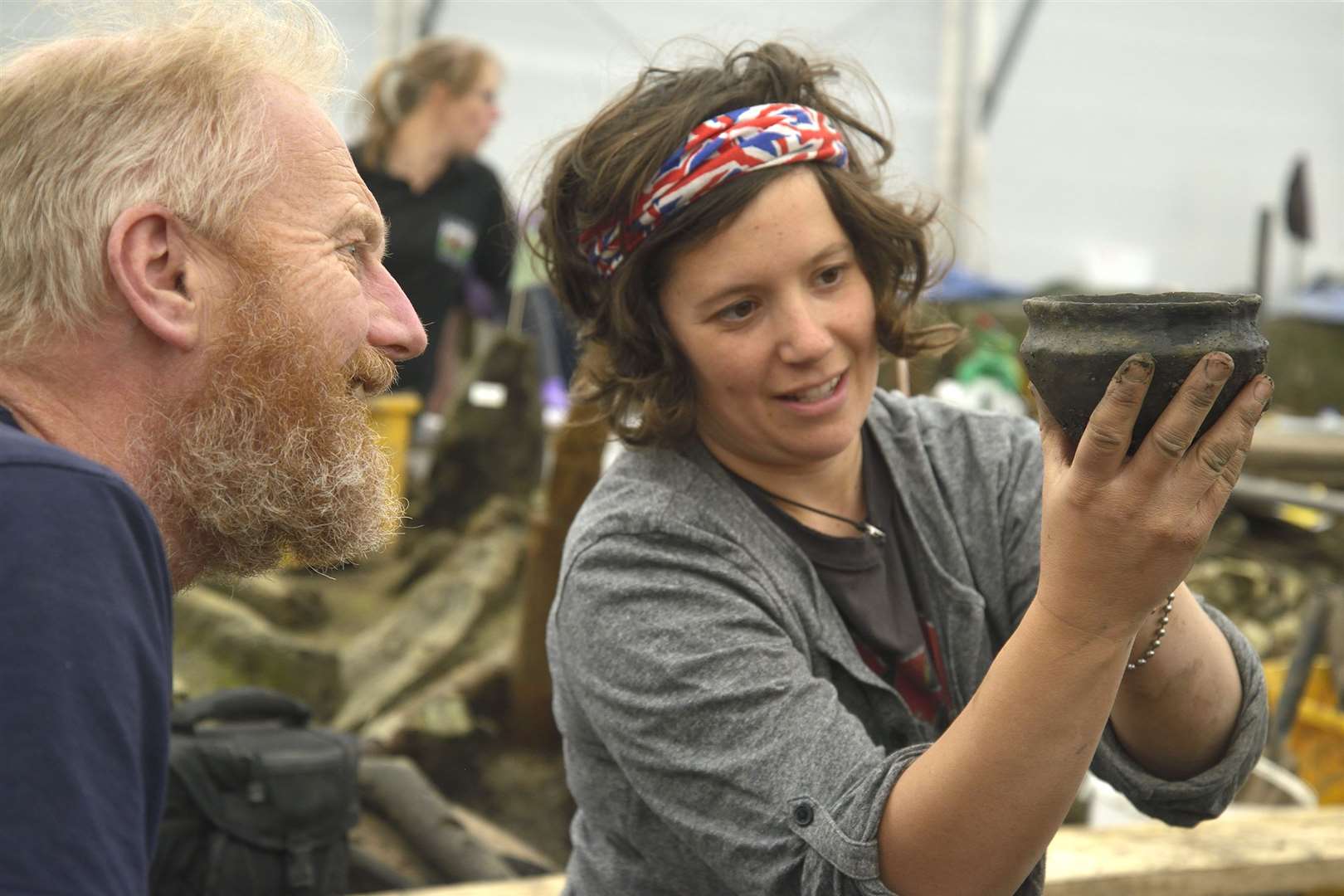 Archaeologists examine a Bronze Age bowl (Cambridge Archaeological Unit/PA)