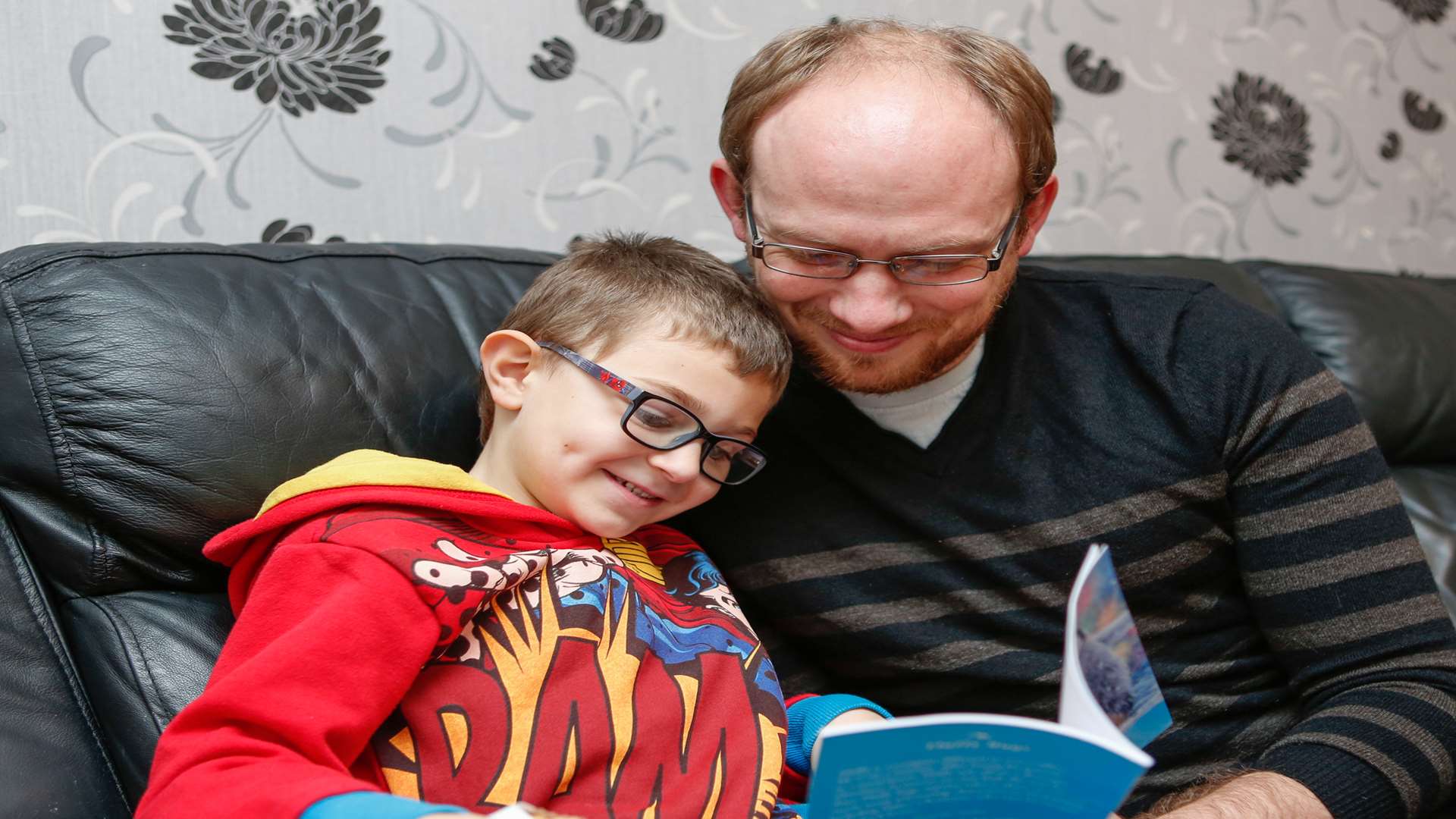 Richard Dodd reading his book to son, Zack. Picture: Matthew Walker