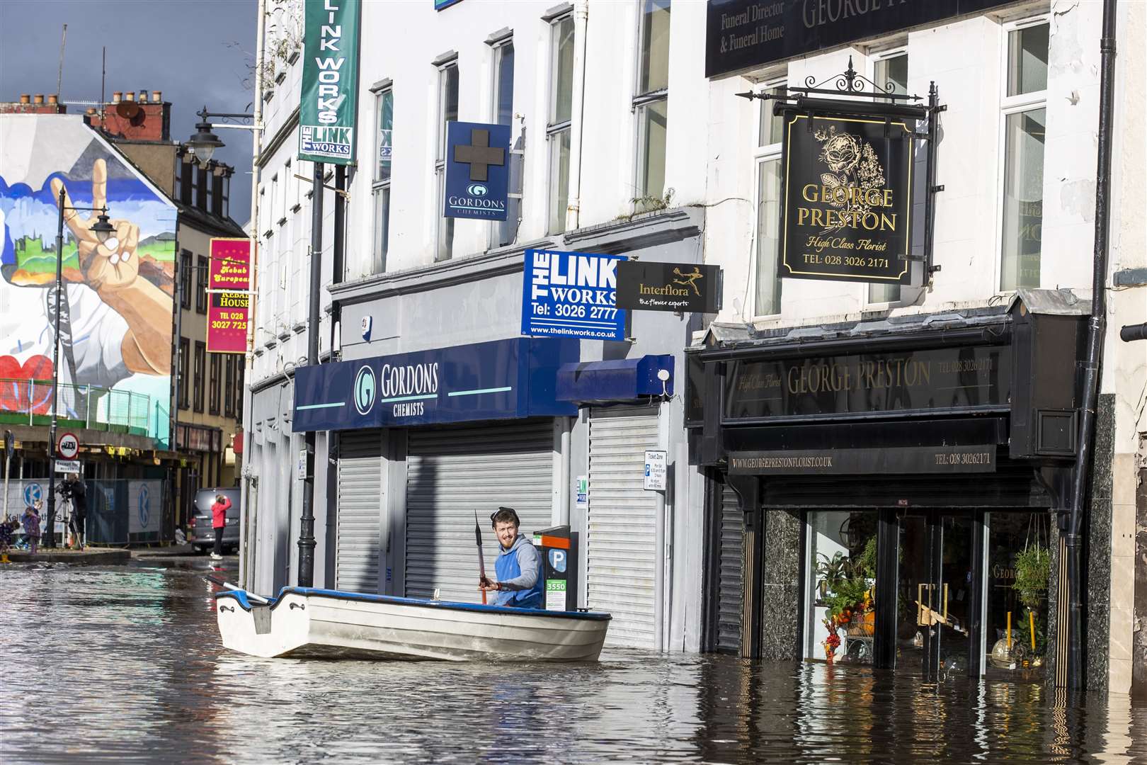 A man canoes down a flooded Sugar Island in Newry, Co Down during flooding caused by heavy rain (Liam McBurney/PA)