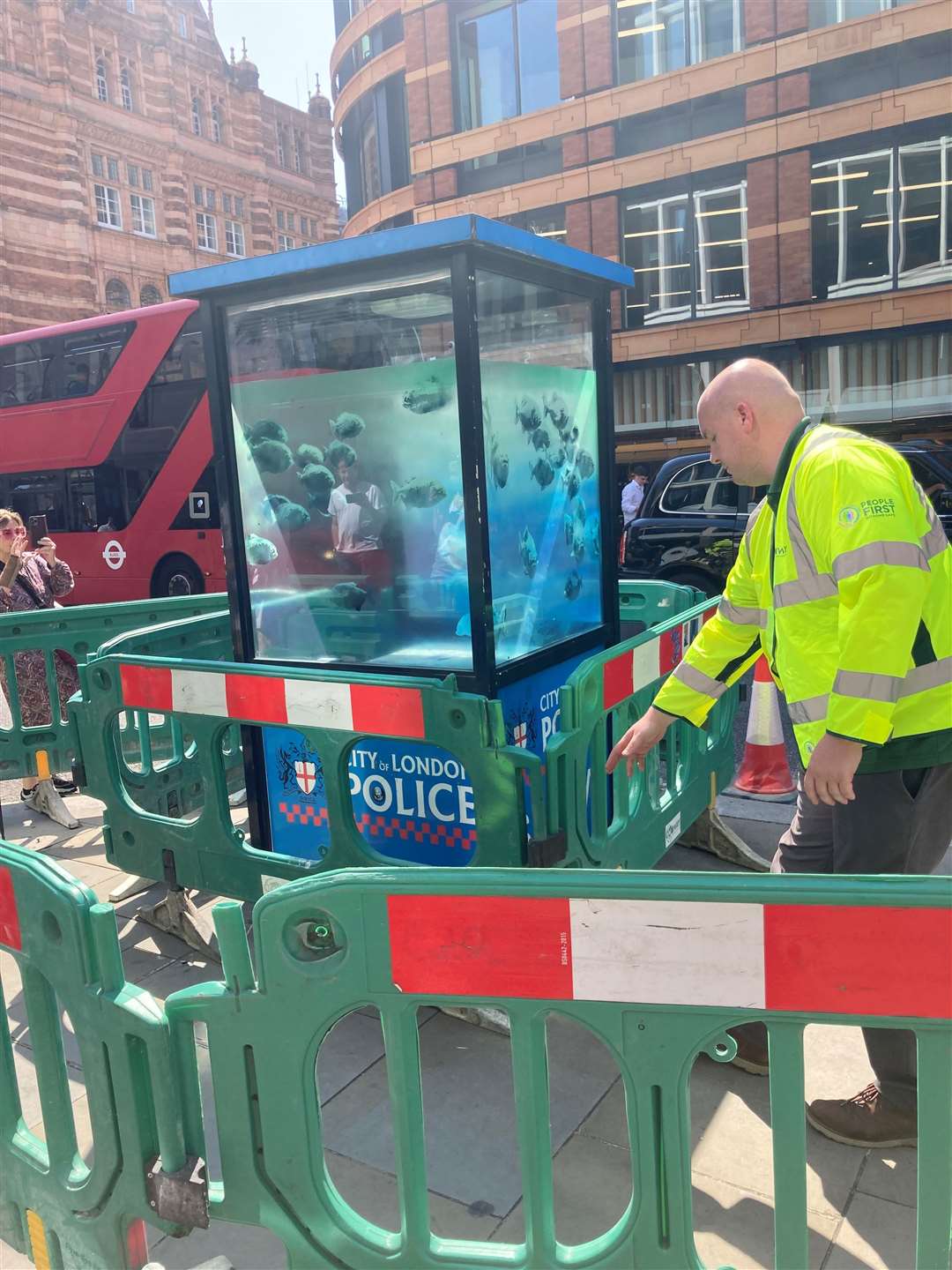 A new design of swimming fish by Banksy, which appeared on a police box in the City of London, is cordoned off (Emily Pennink/PA)