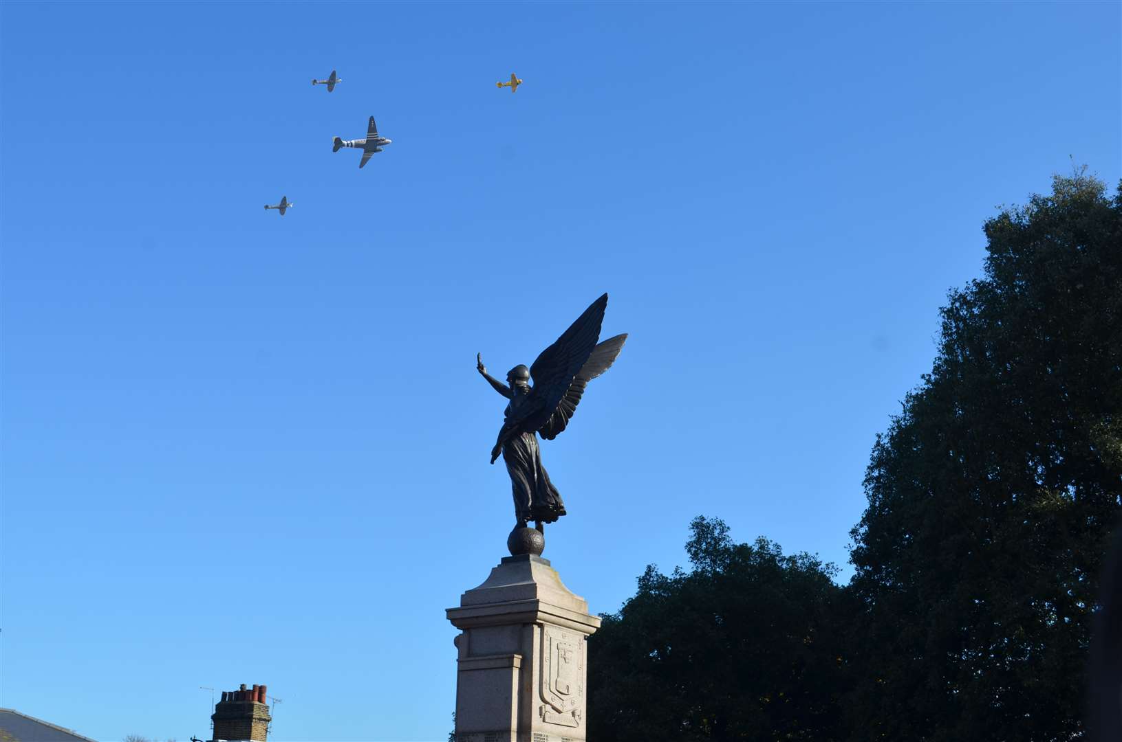 A Dakota and two Spitfires heading to the White Cliffs to drop 750,000 poppies flew over the Gravesend service at Windmill Hill. Photo: Jason Arthur (21350223)