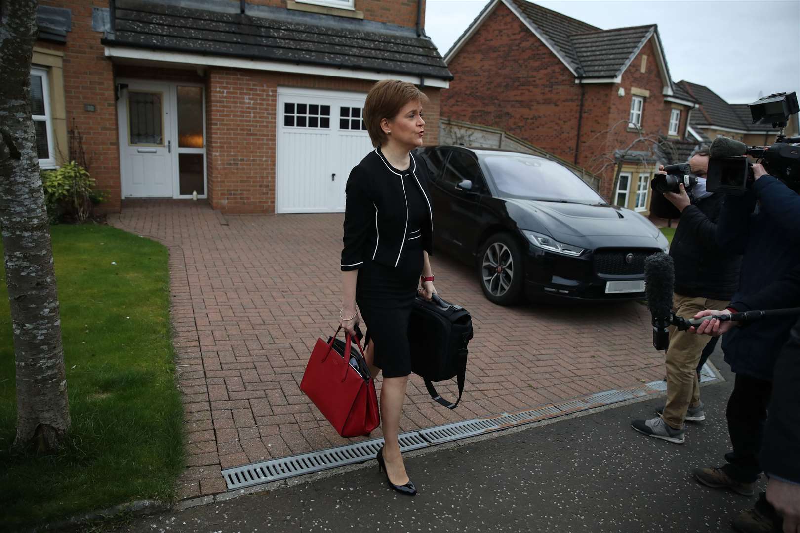 First Minister of Scotland, Nicola Sturgeon, leaves her home in Glasgow (Andrew Milligan/PA)