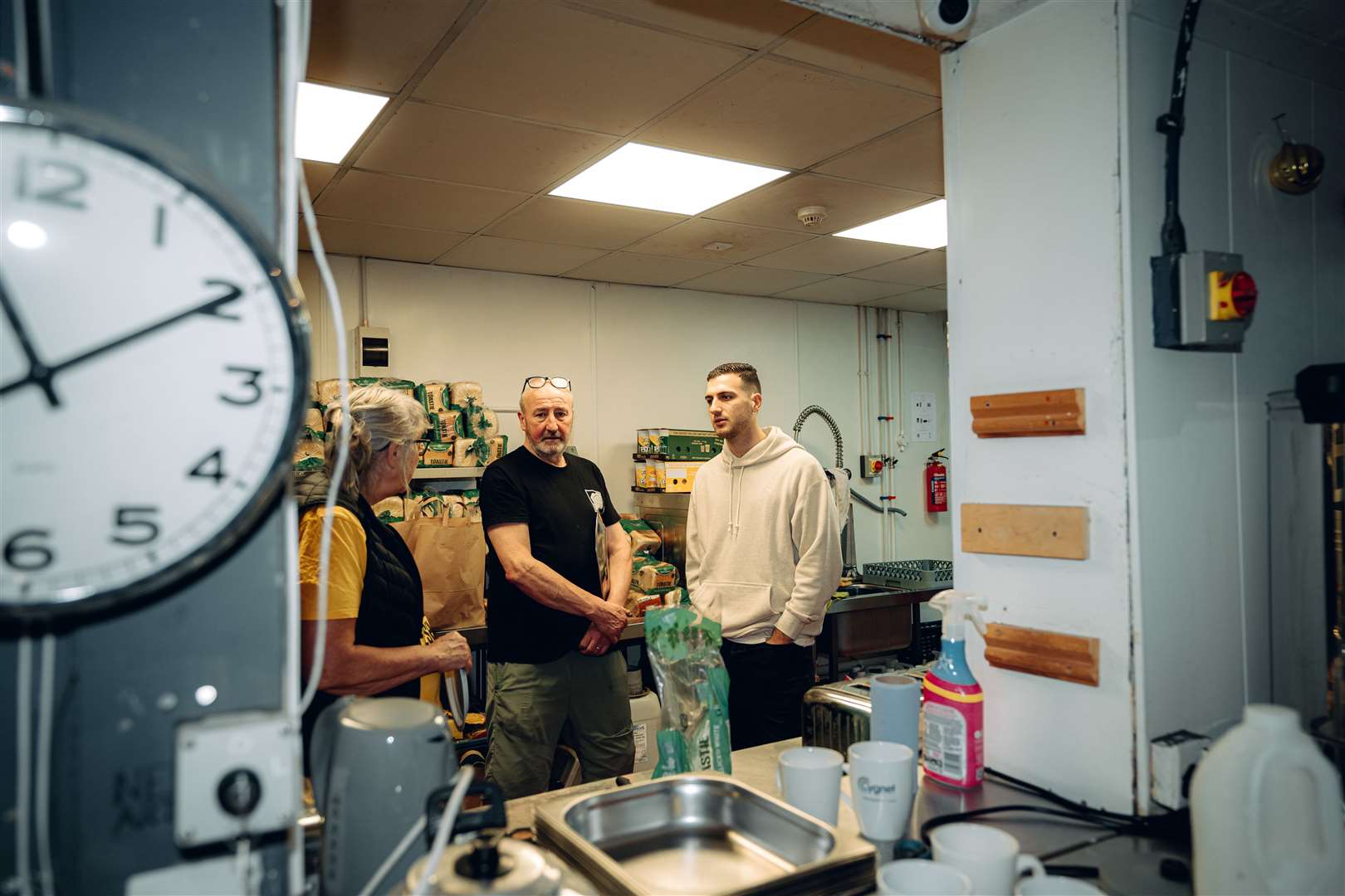 The football player, right, and his partner helped serve hot meals to more than 100 people during their visit (Zohaib Alam/Manchester United/PA)