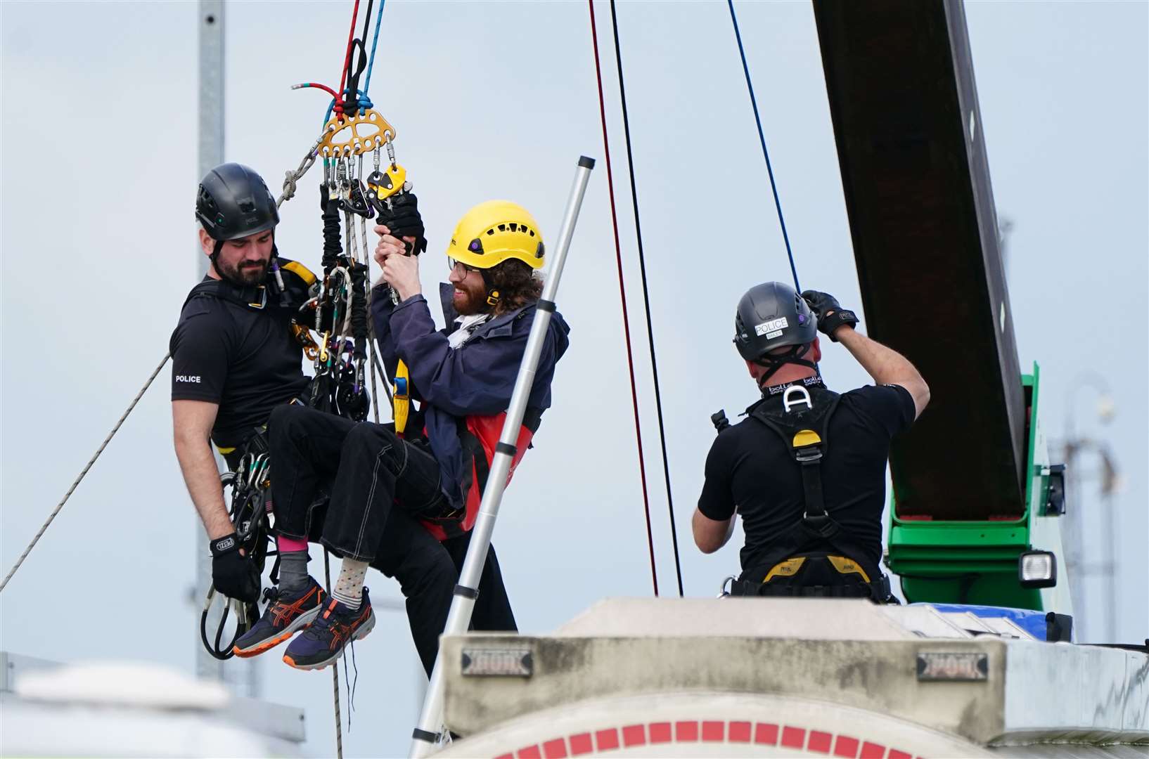 Police remove protesters from This Is Rigged as they sit on top of an oil tanker at the Ineos refinery in Grangemouth (Jane Barlow/PA)