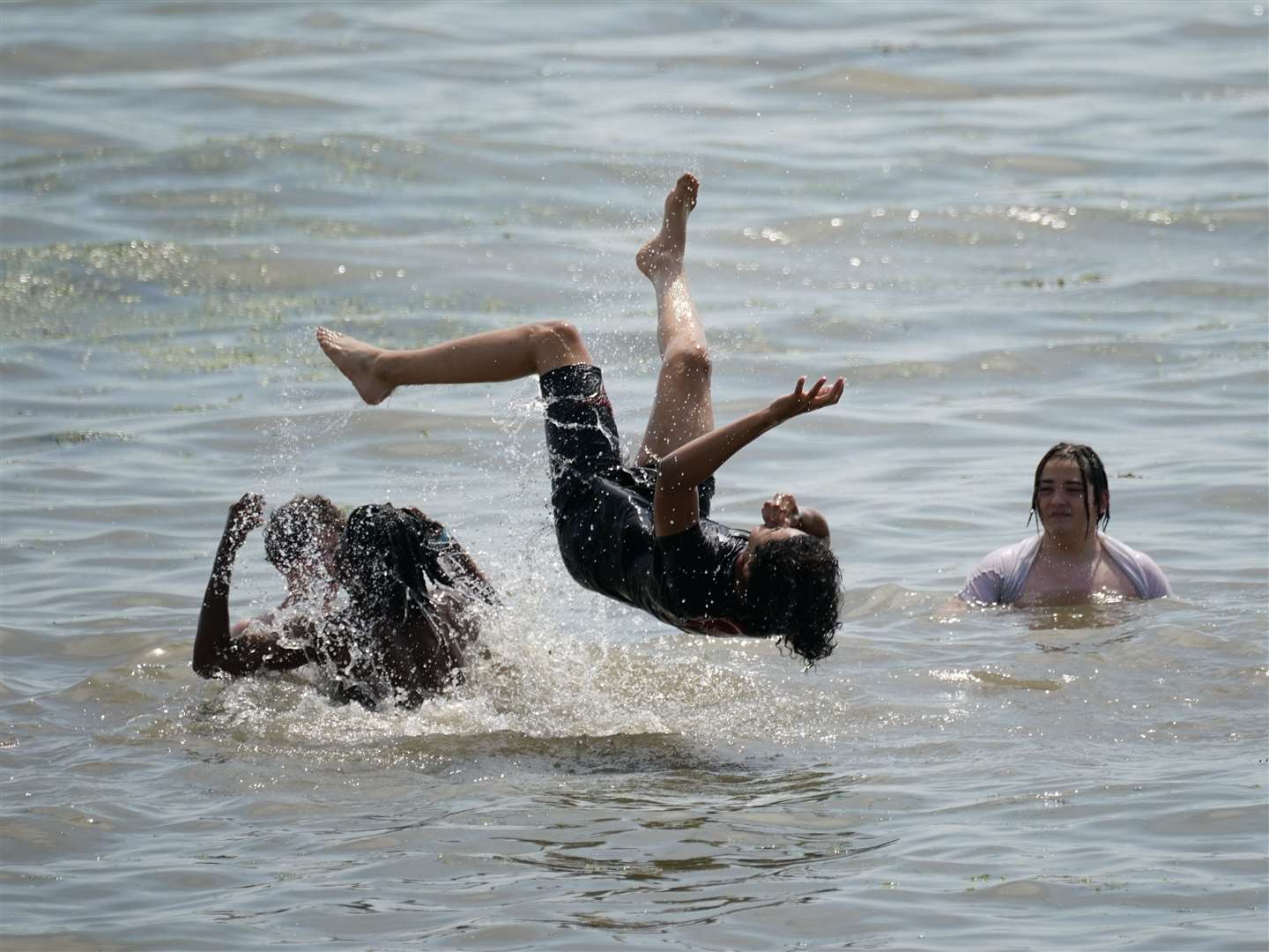 People play in the water at Southend-on-Sea on the Thames Estuary in Essex (Yui Mok/PA)