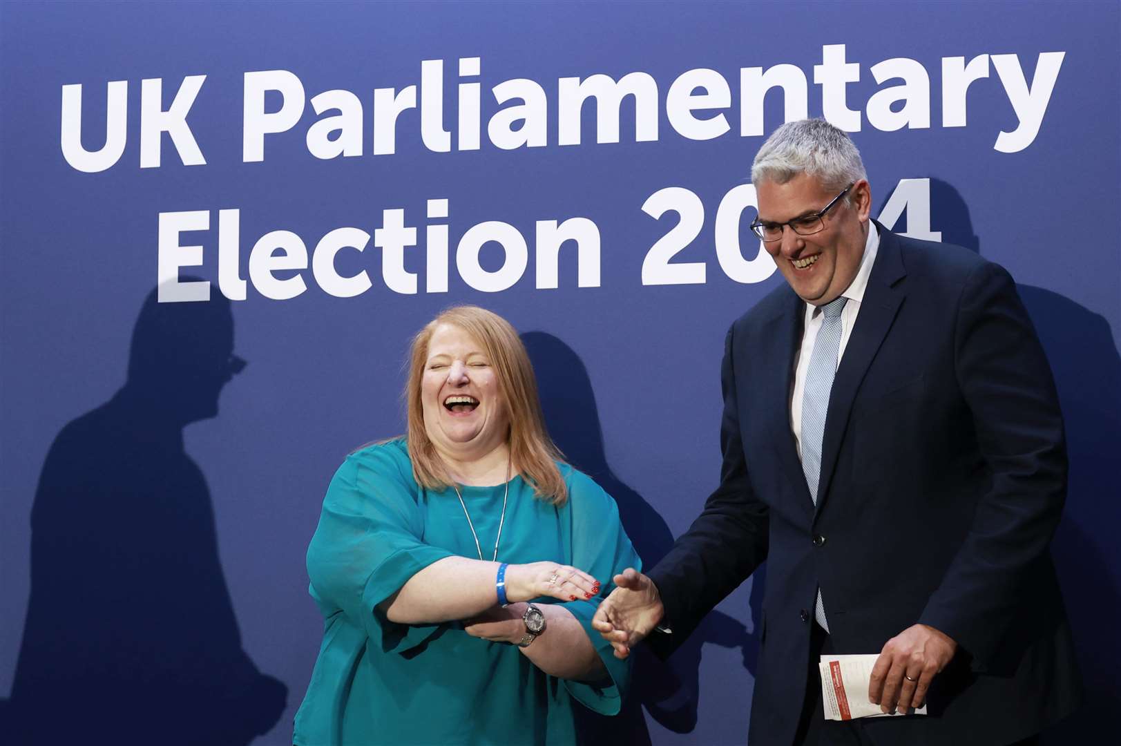 DUP leader Gavin Robinson shakes hands at the Titanic Exhibition Centre with Alliance Party leader Naomi Long after retaining his seat in the East Belfast constituency (Liam McBurney/PA)