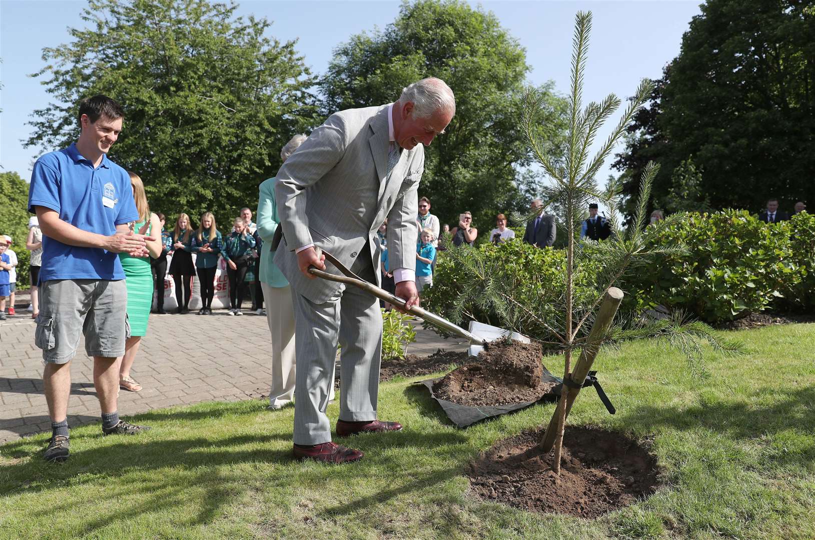 The Prince of Wales, pictured planting a Scots Pine tree during a visit to the Castlebank Park and Horticultural Centre in Lanark, is known for his love of the natural world (Andrew Milligan/PA)