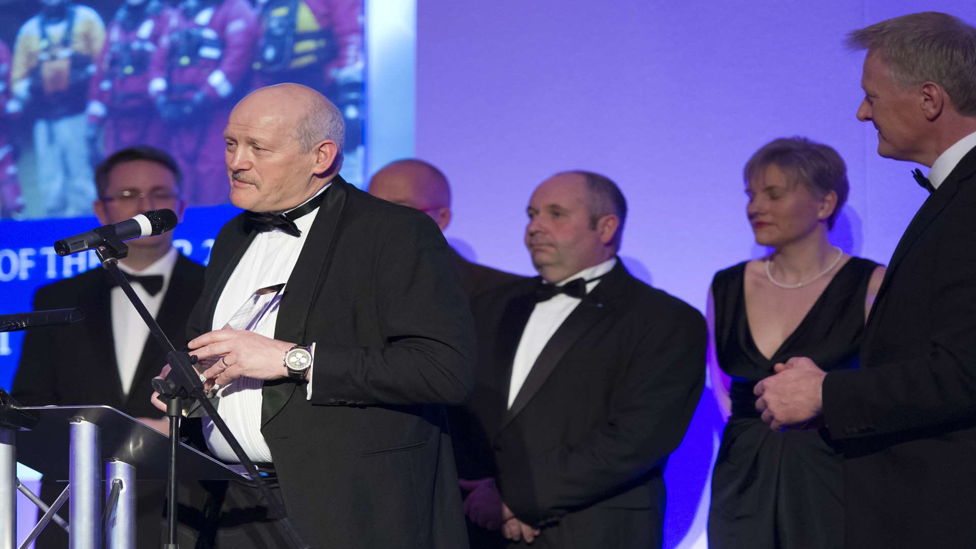 Paul Lewis, from overall winners 2015, Kent Search and Rescue, accepts the award on-stage