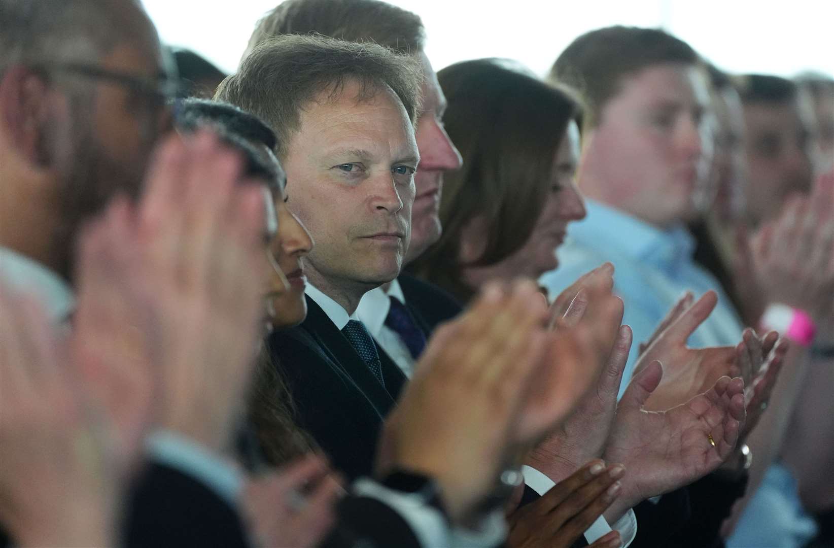 Defence Secretary Grant Shapps looks pensive as he listens to Mr Sunak’s speech (James Manning/PA)