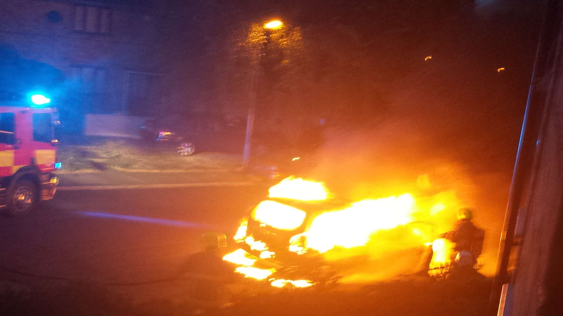 A firefighter tackles a blazing car in Faversham. Picture: Richard Brittain