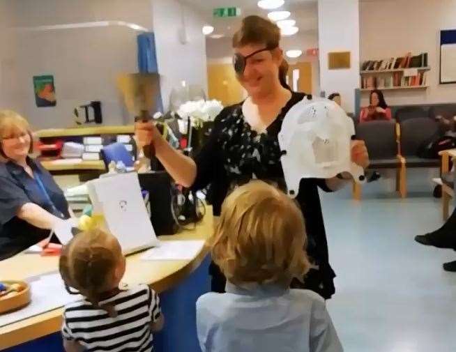 Toni Crews ring the bell to mark the end of her cancer treatment