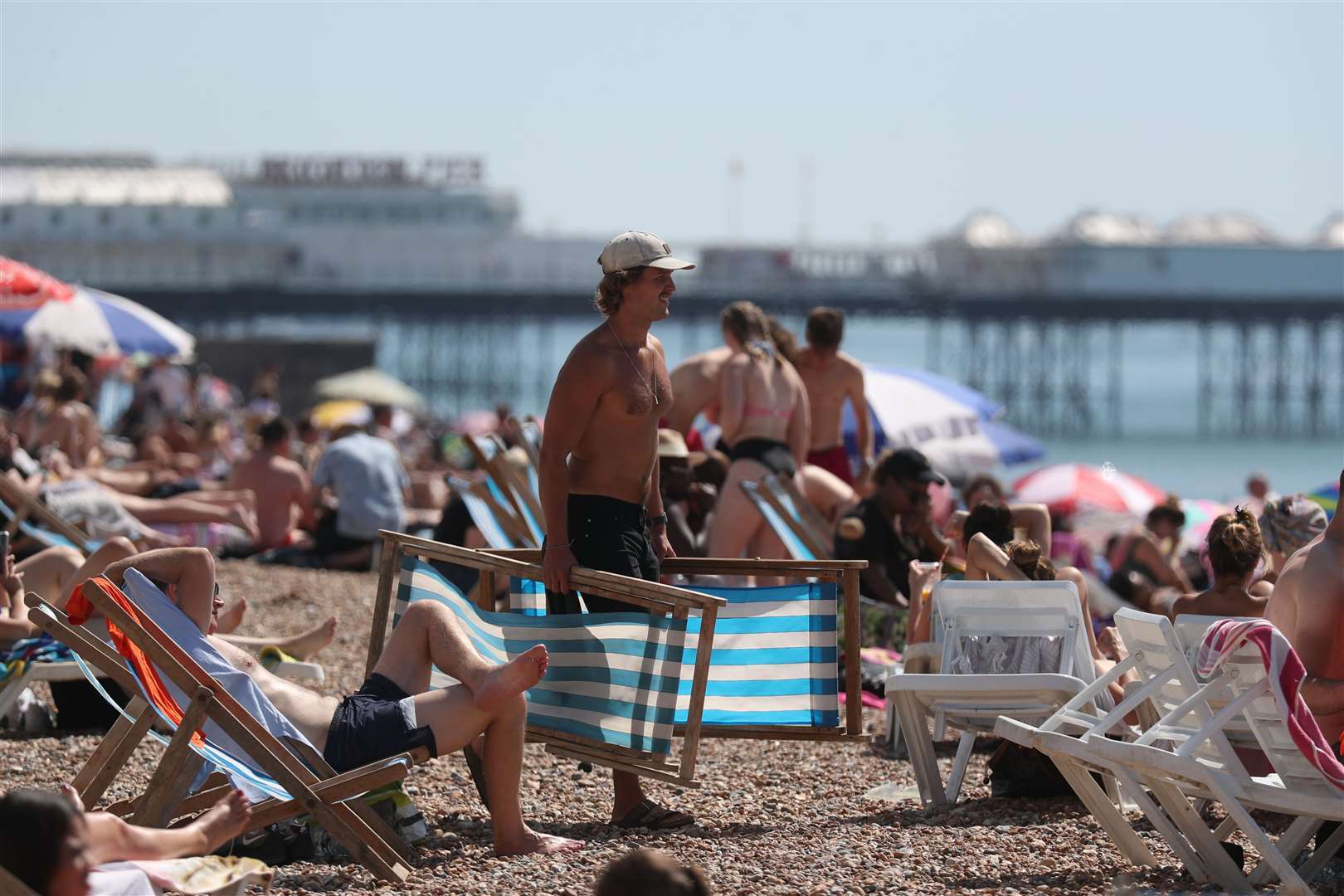 People enjoy the weather at Brighton beach (Steve Parsons/PA)