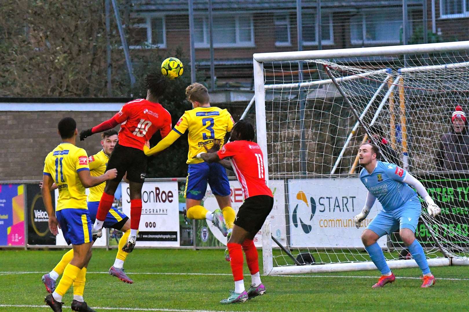 Sheppey’s Victor Aiyebula attacks the ball at Lancing and, right, the visiting players are not impressed with a challenge on Jacob Lambert Pictures: Marc Richards