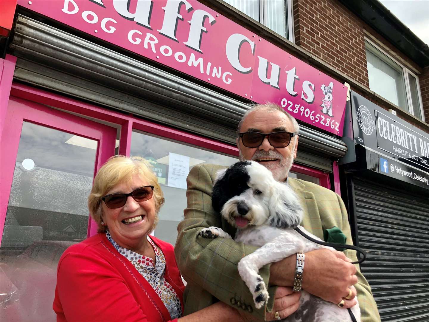 Robert and Isobel Campton, from east Belfast, were delighted to get their seven-month-old cockapoo Patch a much-needed trim (David Young/PA)