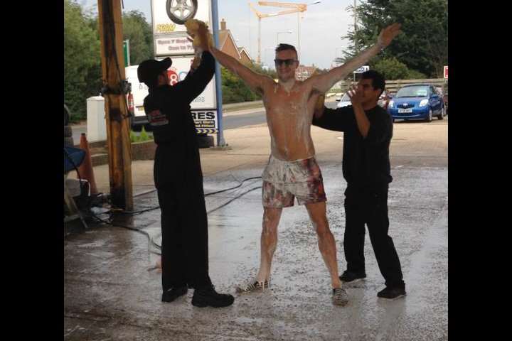 Prankster Mr Lee Marshall enjoys his human car wash in Hersden