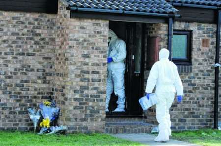 Floral tributes outside the bunglaow as forensic officers continue their investigation