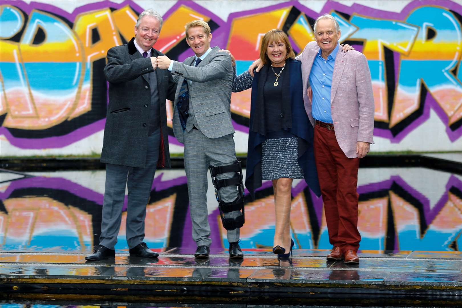 Chauntry chief technology officer Ray Vaughan, Holiday Extras Group chief executive Matthew Pack, Chauntry chief executive Theresa Hughes and Holiday Extras founder and non-executive director Gerry Pack celebrate after signing the acquisition deal outside a new building on the Holiday Extras campus, due to open next June