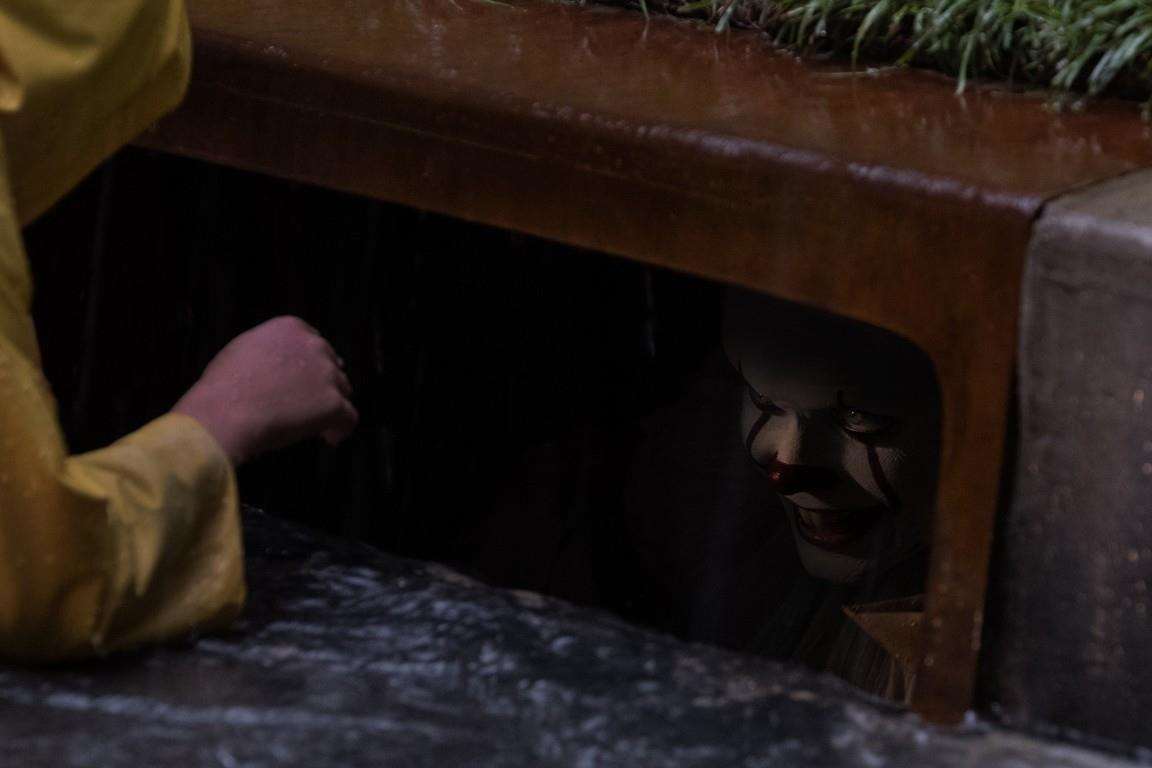 Creepy clown hiding in a drain. Still from the film It. (4607801)