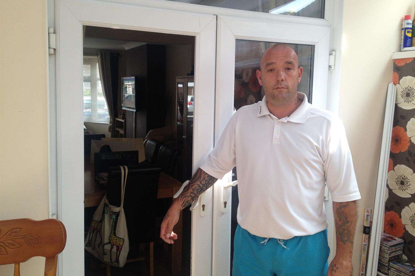 Scott Langworthy by the patio door which was smashed at his home in St Helen's Road, Sheerness