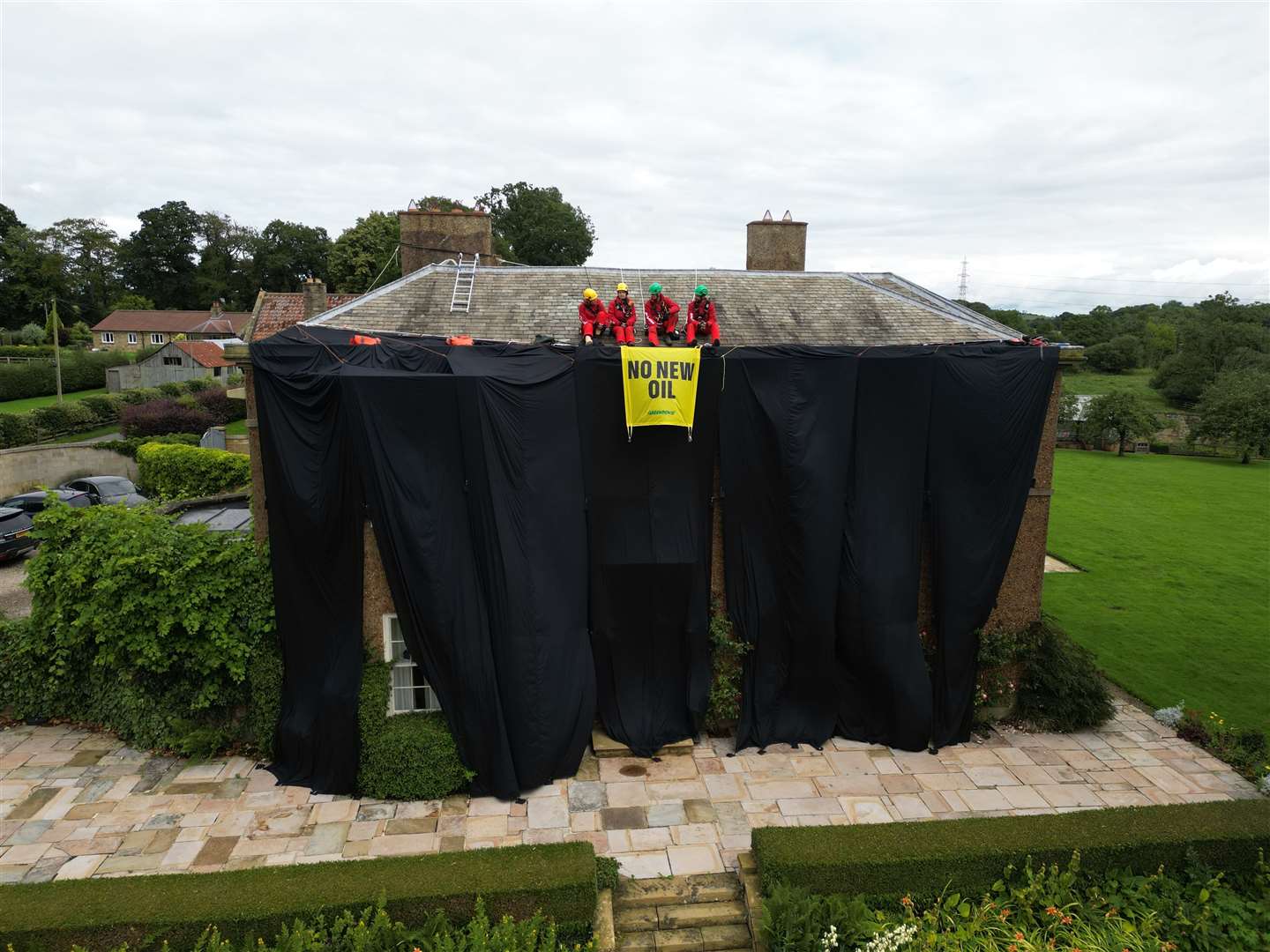 Greenpeace activists on the roof of Prime Minister Rishi Sunak’s house in Richmond (Danny Lawson/PA)