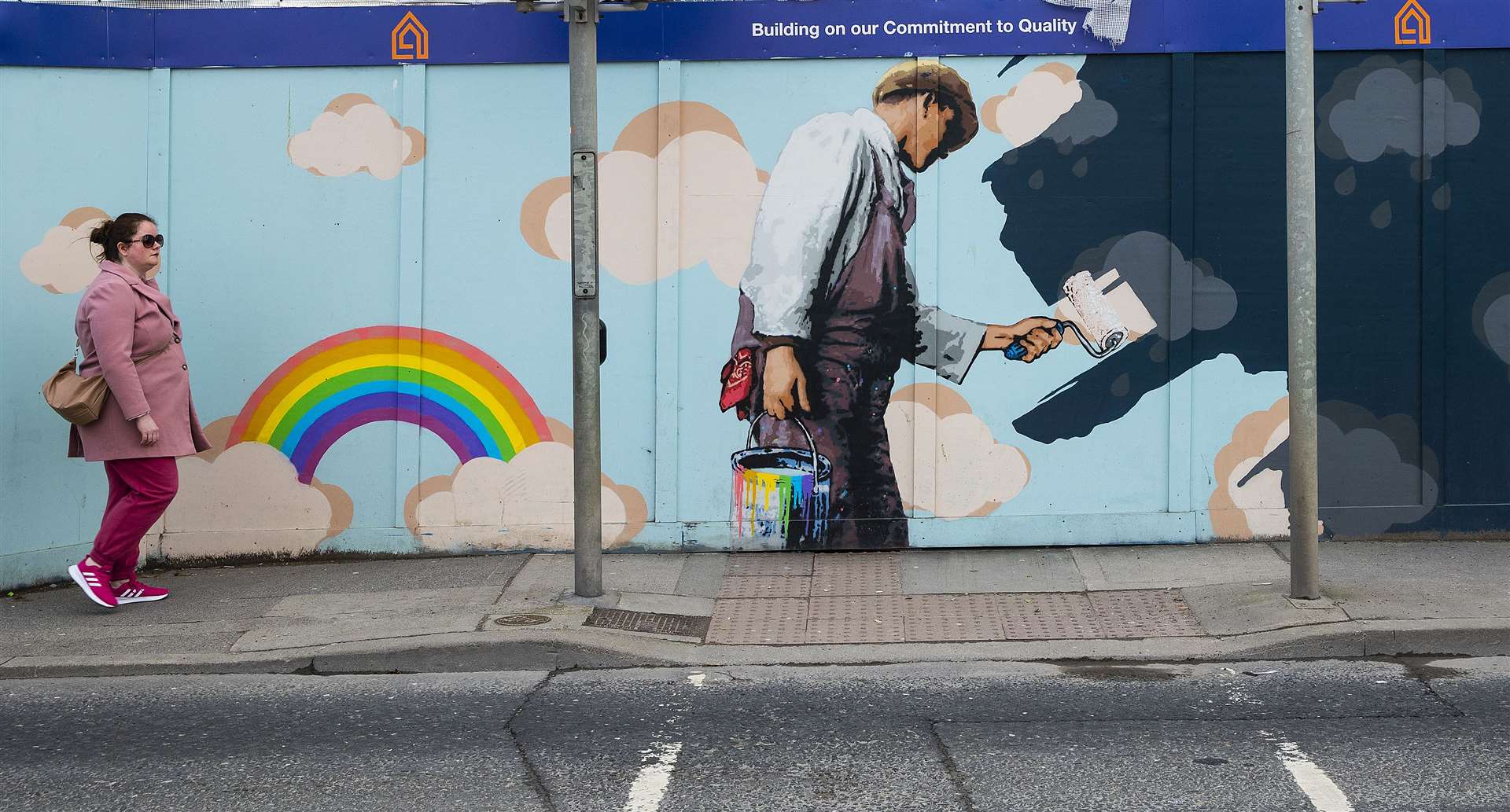 A woman walks past a mental health-related mural in Dublin (Brian Lawless/PA)