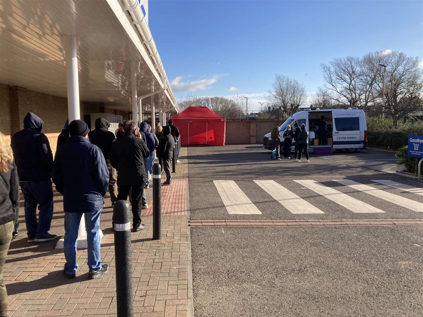 Queue to have a Covid booster jab stretched around Tesco supermarket in Bridge Road