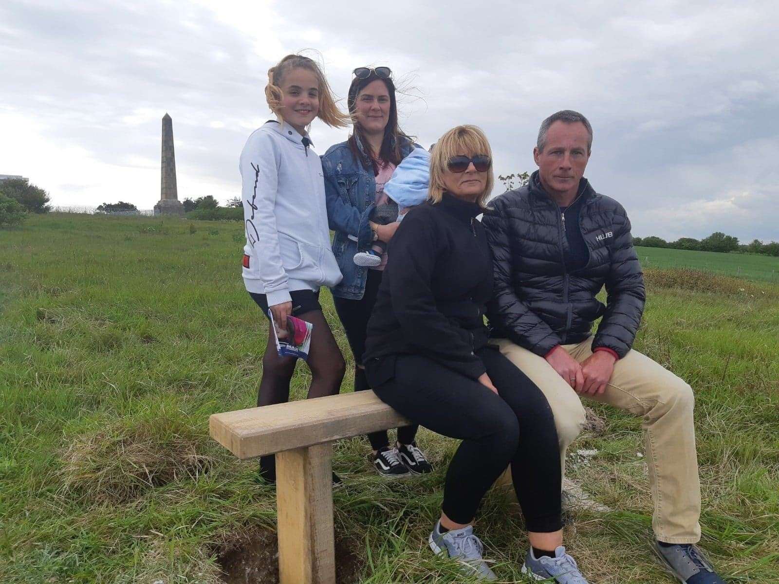 Daniel Squire's family niece Keira, sister Hayley, nephew Ezra and parents Tracy and Symon Squire gather at the bench