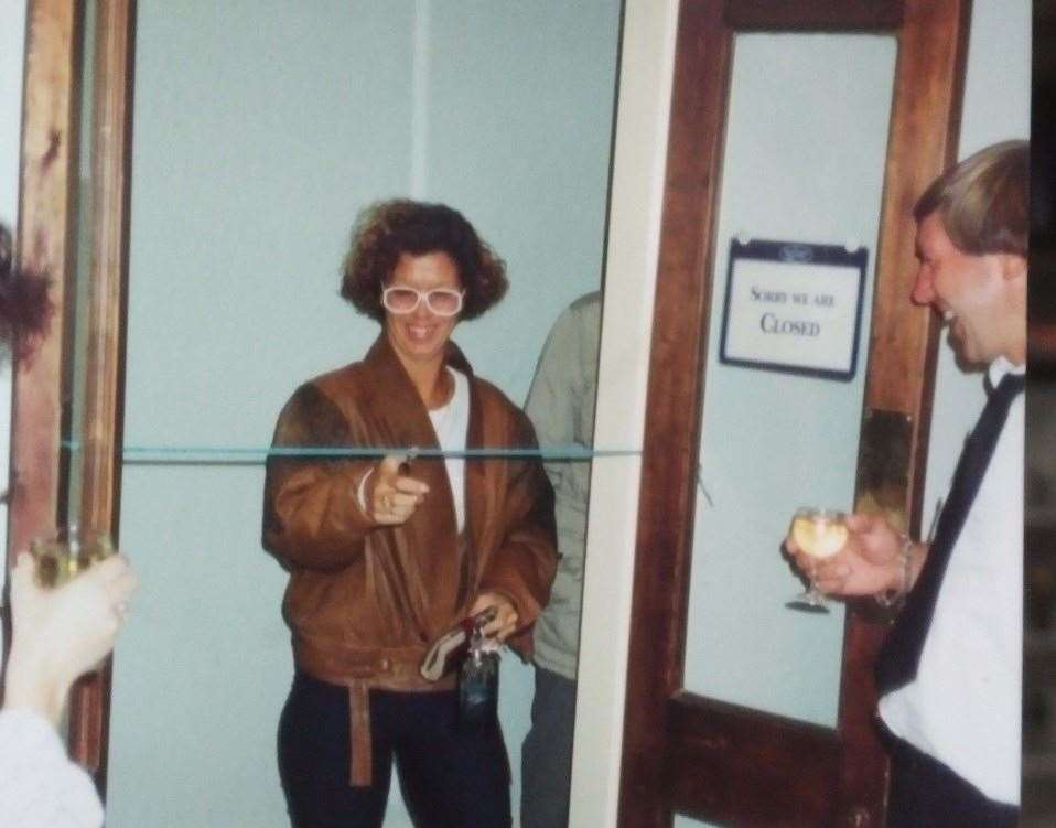 Cynthia, owner of the salon, cuts the ribbon during a ceremony. Her late husband George is also pictured