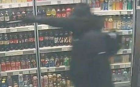 Frankie Whittington holding a meat cleaver up to the newsagents' worker in Gravesend. Picture: Kent Police