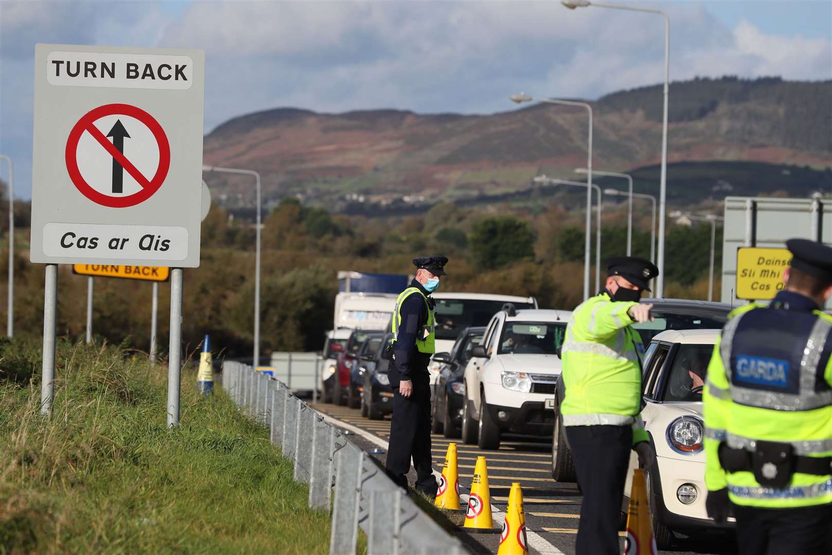 Cars queue at the border crossing between Northern Ireland and the Republic of Ireland, as gardai conduct checks asking people the reason for their journey (Brian Lawless/PA)