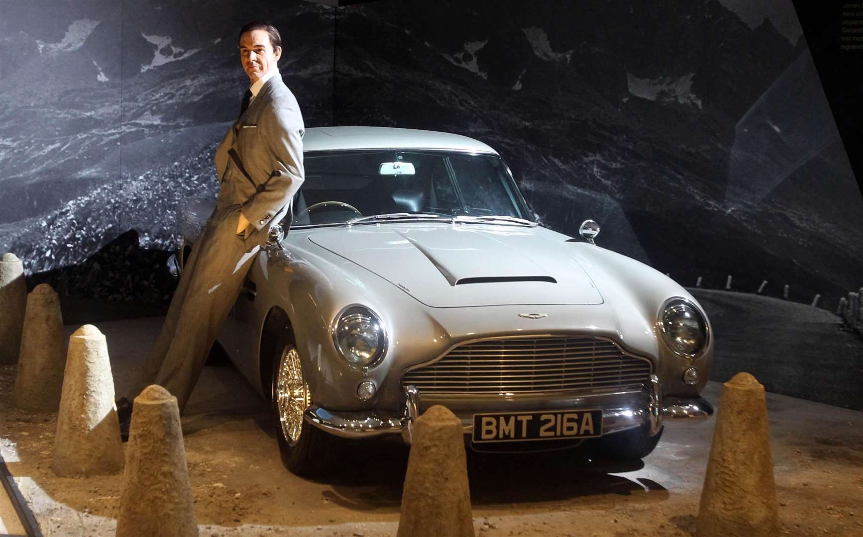 A waxwork of Sir Sean Connery posing with an Aston Martin DB5 (Lewis Whyld/PA)