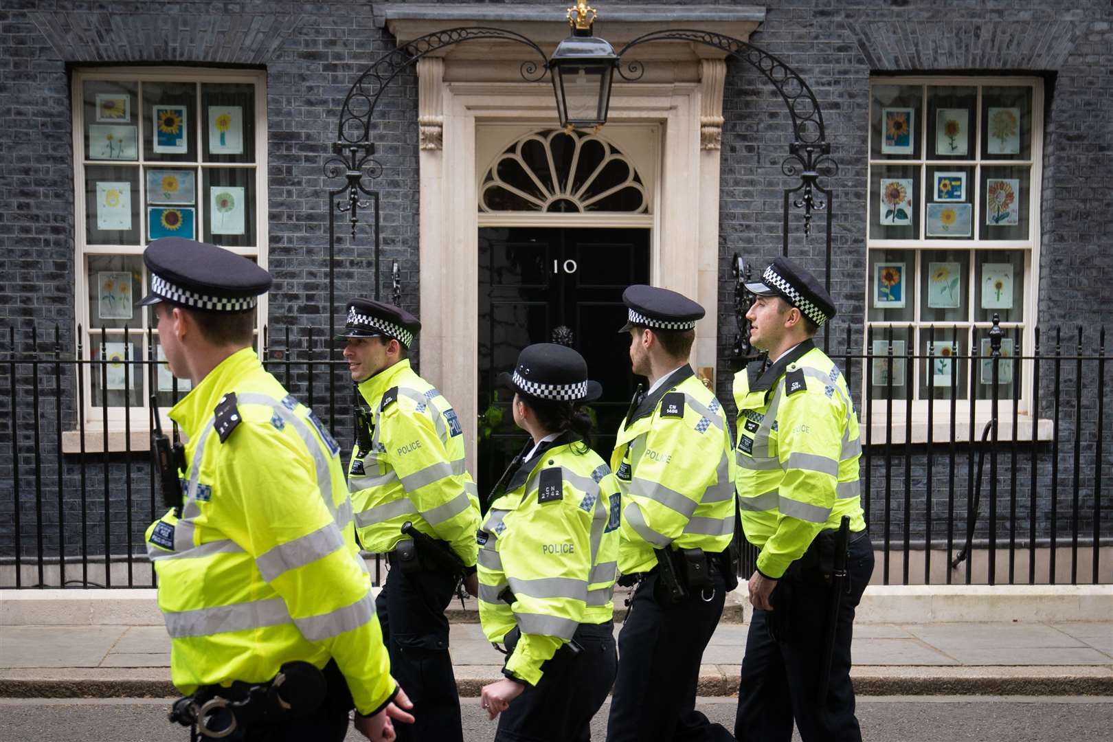 A group of police officers walk through Downing Street (Stefan Rousseau/PA)