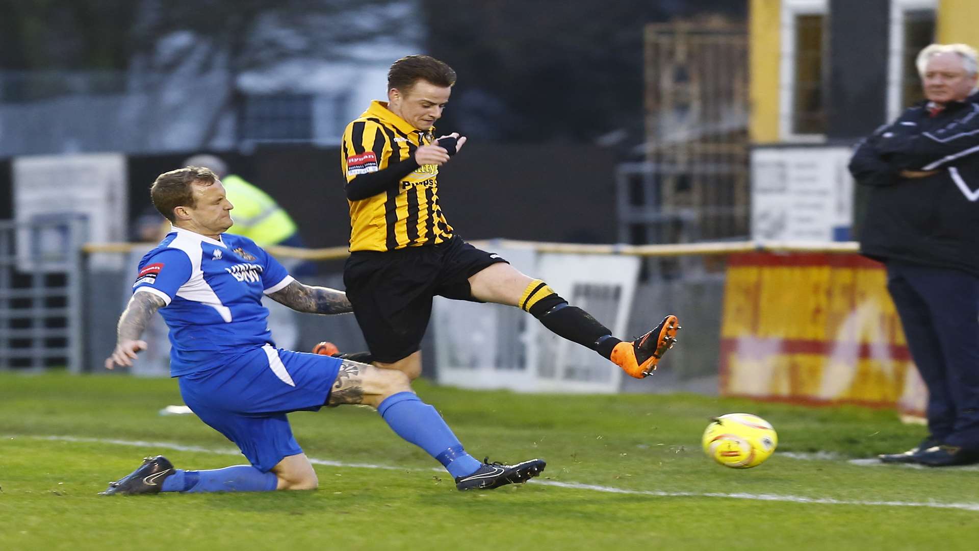 Neil Cugley looks on as Jordan Wright hurdles a challenge during Folkestone's win over Three Bridges Picture: Matt Bristow