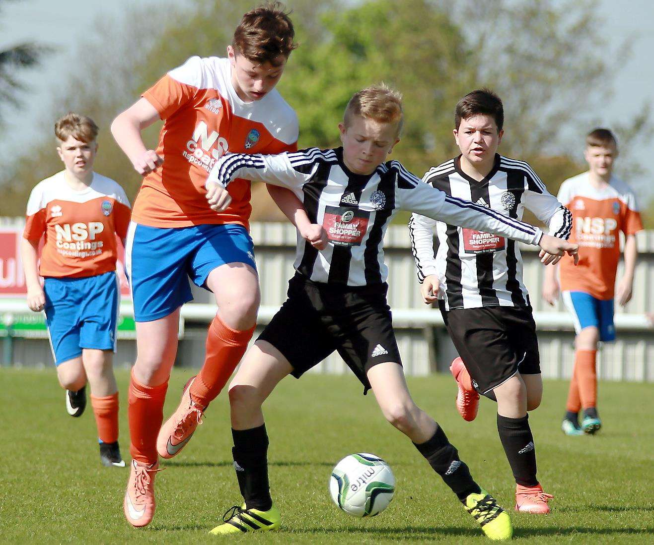 Cuxton 91 (orange) and Real 60 Tigers went head-to-head in the Under-13 John Leeds Trophy final on Sunday. Picture: Phil Lee FM1586519