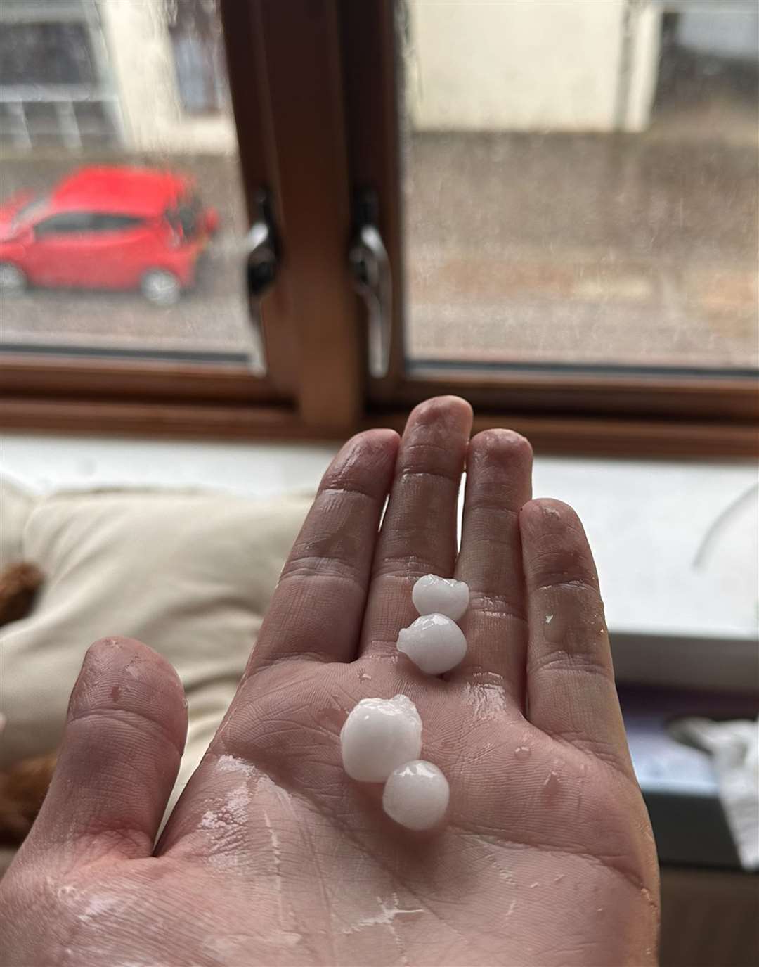 George Dibley holding hail stones (George Dibley/PA)