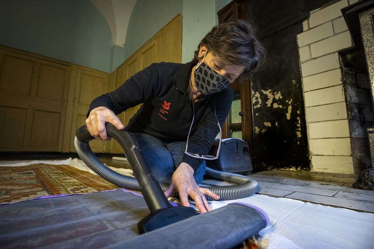 Castle Ward Collections Assistant Emma McCullough gently hoovering dust from a rug (Liam McBurney/PA)