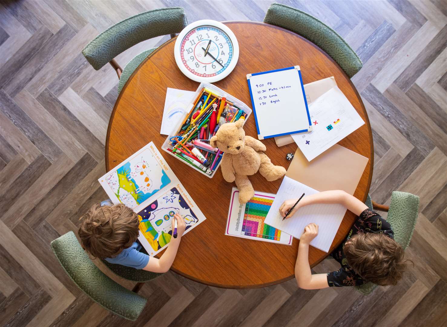 Pupils work at the dining table as they take part in home schooling (Dominic Lipinski/PA)