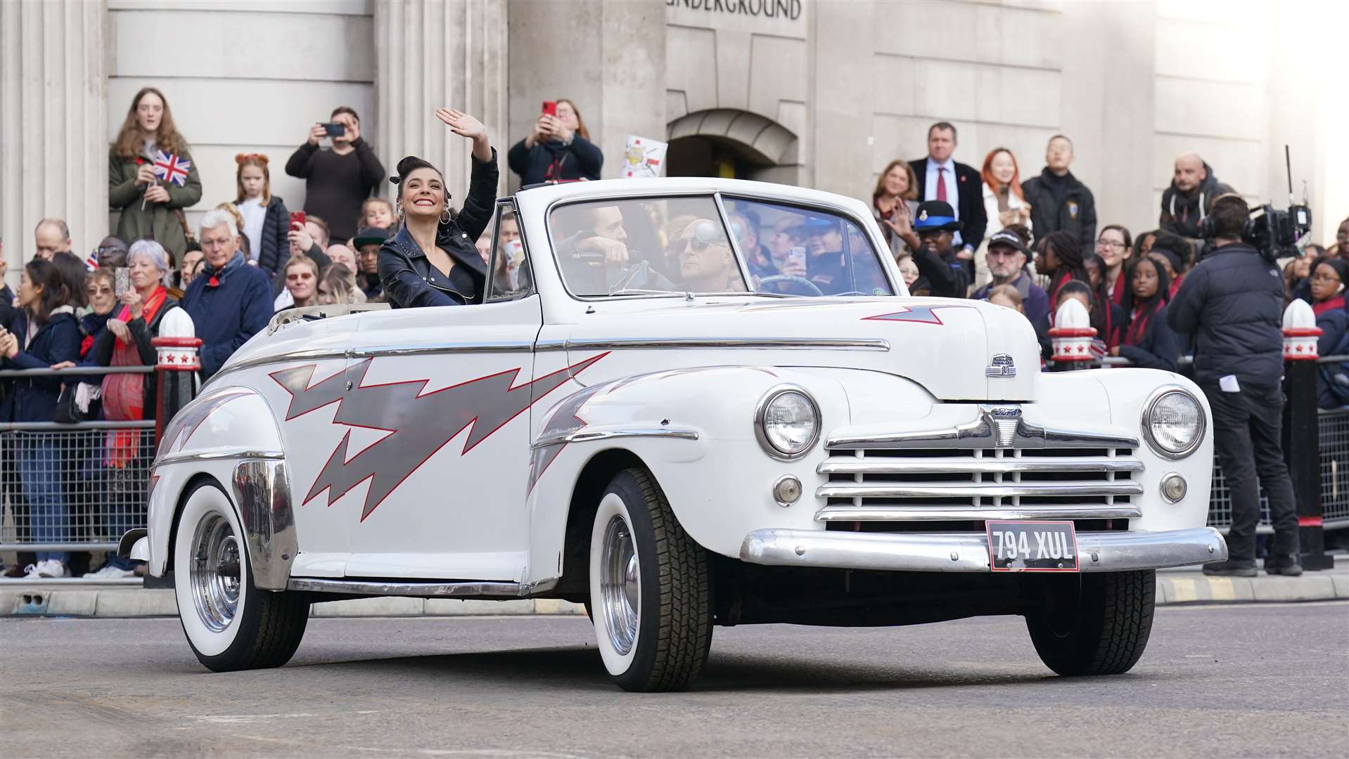 Cast members from the West End show Grease joined in with their hot rod from the musical (Jonathan Brady/PA)