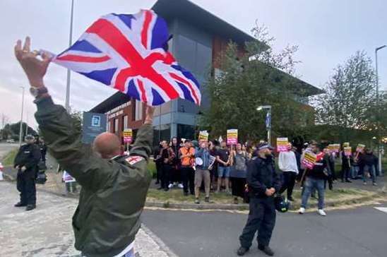 A man waving a Union Flag opposite anti-racism protesters in Chatham