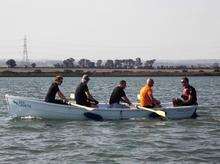 A fresh team of rowers take up the oars