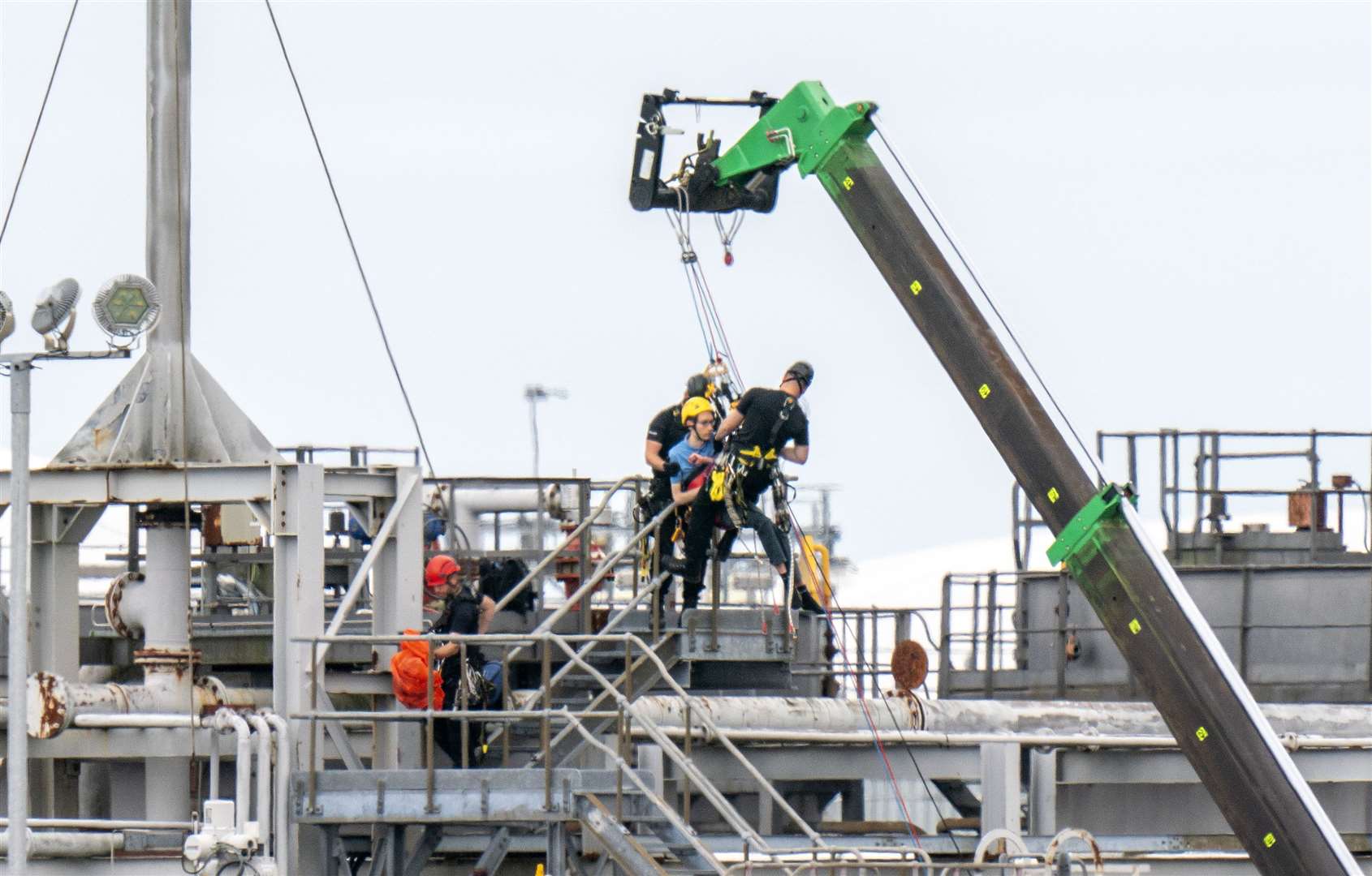 Protesters from This Is Rigged are removed by police officers using a crane at the Ineos refinery in Grangemouth (Jane Barlow/PA)