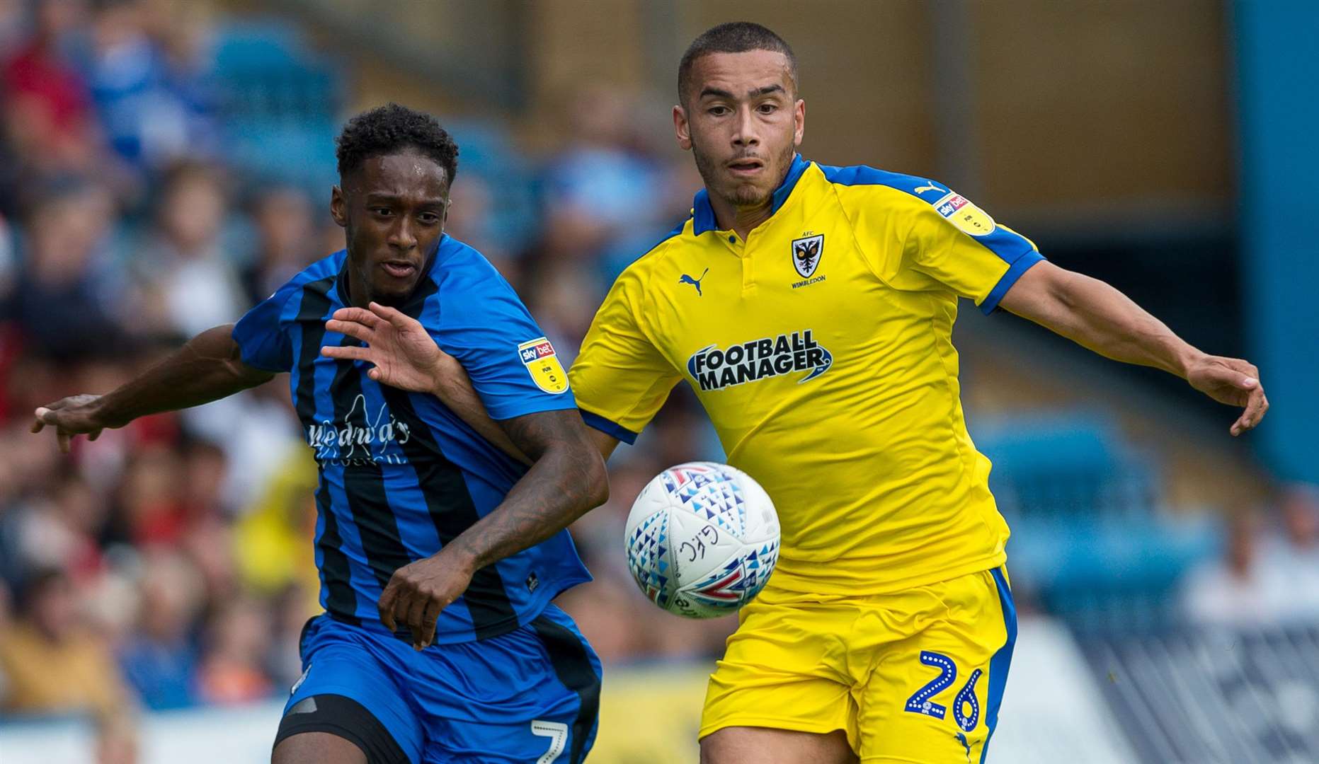 Brandon Hanlan challenges with AFC Wimbledon's Rod McDonald Picture: Ady Kerry