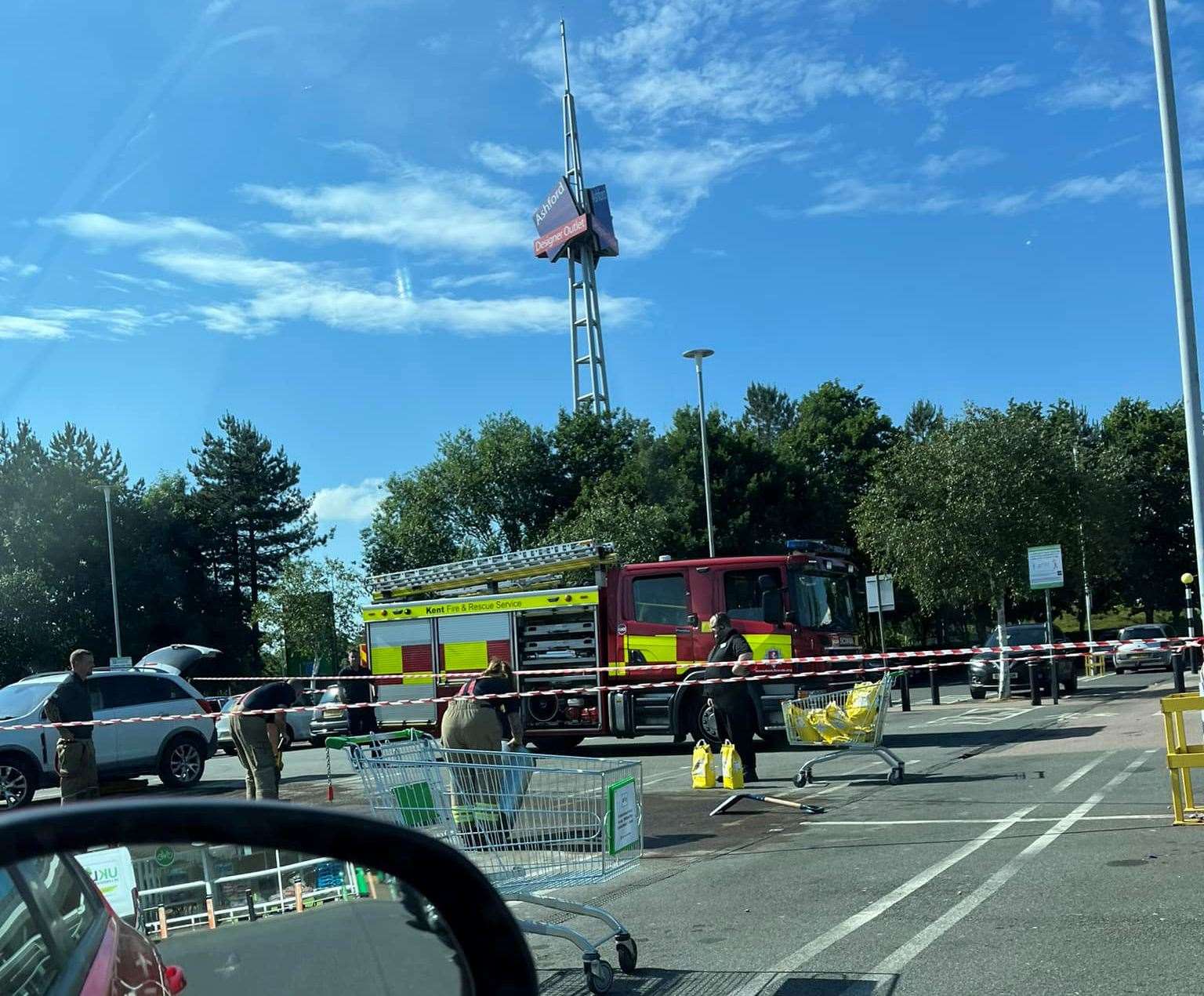 Firefighters have been pictured in Asda supermarket car park in Ashford this evening