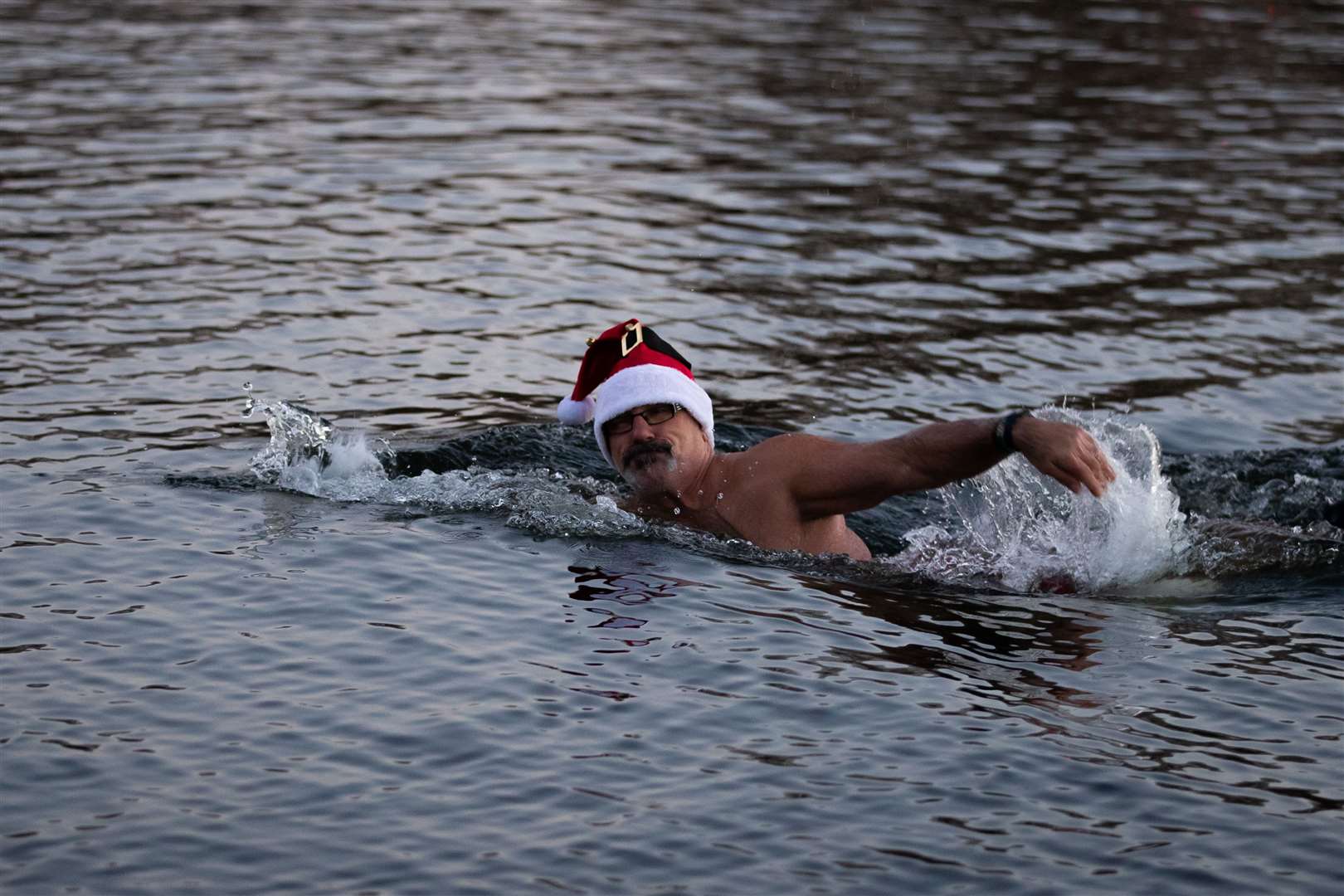 Swimmers took to the water, despite the Peter Pan Cup, the annual Christmas Day race run by the Serpentine Swimming Club, being cancelled due to the coronavirus restrictions in Tier 4 London (Aaron Chown/PA)