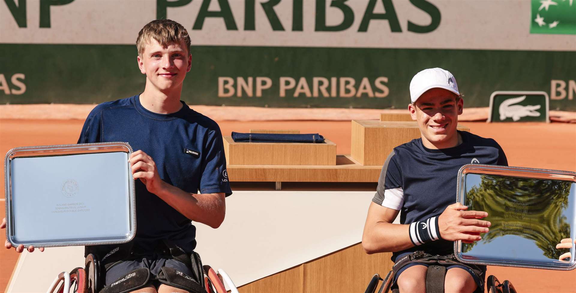 Canterbury’s Ruben Harris, left, celebrates his boys' wheelchair doubles triumph at the French Open alongside partner Maximilian Taucher in Paris. Picture: Frank Molter