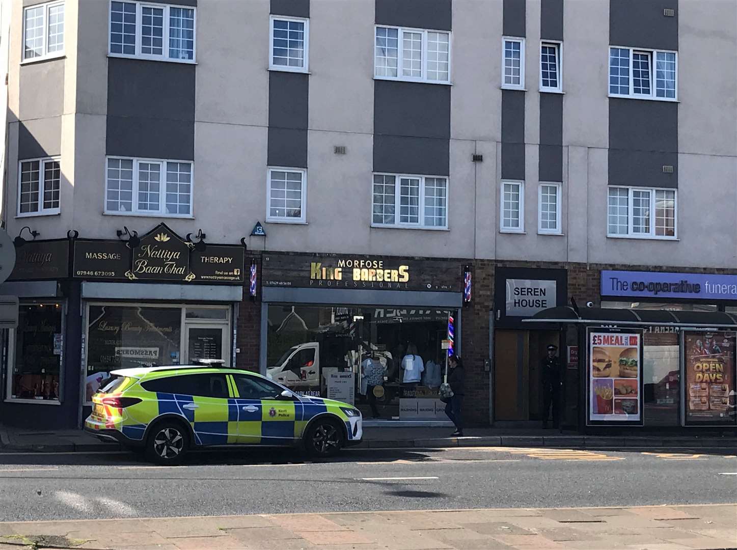 Police were spotted parked outside a Thai massage parlour and a barbers in Strood this morning