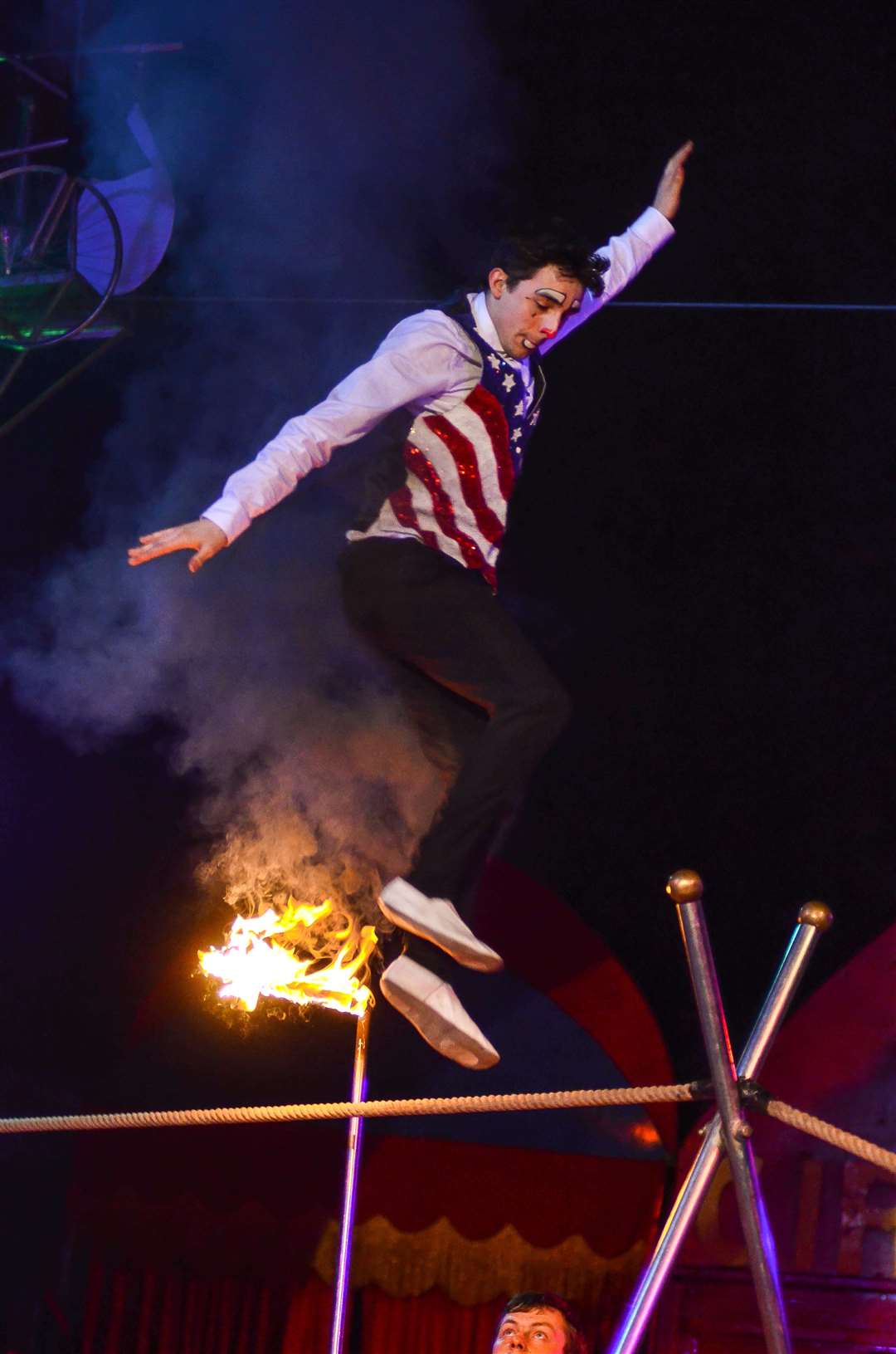 Clown Lucien Santus jumps fire on the tight rope at Santus Circus. Picture: Santus Circus