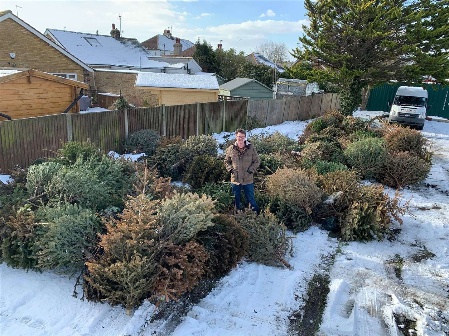 Cllr Chris Cornell pictured here in Whitstable Town Football Club's car park with the Christmas trees he helped to remove from the streets. Picture: Chris Cornell
